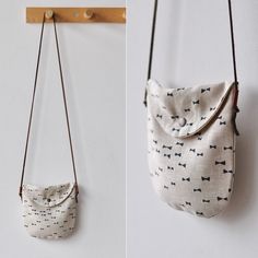 two bags hanging on the wall and one has a small purse with handles attached to it