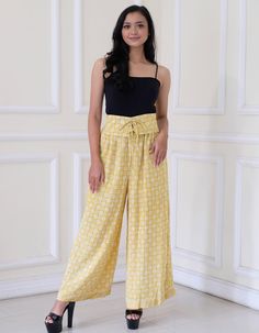 Batik elastic waist pants made with Indonesian batik cotton fabric.  Fit and Sizing: Female model is 160 cm tall. Yellow: Size chart: Medium: waist up to 82 cm (33 in), hip 88 cm (35 in), length 102 cm (41 in) Details: All around elastic waist band with corset like closure. Side pockets. Beige/Green Size chart: L (Large): waist 61-99 cm (24-39 in), hip up to 102 cm (40 in), length 82.5 cm (32.5 in) XL (Extra Large): waist 78-114 cm (27-45 in), hip up to 118 cm (46 in), length 85 cm (33.5 in) Det Yellow High Waist Cotton Wide Leg Pants, Patterned Cotton Trousers, Yellow Wide-leg Harem Pants With Elastic Waistband, Summer Cotton Bottoms With Batik Print, Casual Batik Print Bottoms For Summer, Indonesian Batik, Hip Ups, Womens Pants, Elastic Waist Pants