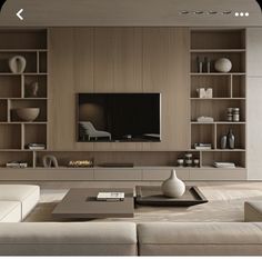 a modern living room with built in shelves and a flat screen tv on the wall