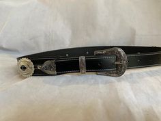 100% Genuine Leather Australian Made  This is Black leather western belt with small and big oval conchos with a Western three piece silver buckle set  , the belt is 38mm (1 1/2") and tapers down to 30mm where it buckles up , made to your requested waist size, waist size is from the buckle end of the leather to the middle hole then you will have three holes bigger and three holes smaller, just add your waist size in message to seller or message me , happy to help in custom work Classic Concho Belt Buckles For Rodeo, Black Belt With Antique Buckle For Rodeo, Western Black Belt Buckles, Western Black Belt Buckle With Belt, Western Black Belt Buckles For Rodeo, Western Style Black Belt For Western-themed Events, Western Style Black Belt For Ranch, Classic Black Concho Belt Buckles, Black Adjustable Belt For Rodeo