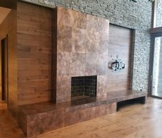 a living room filled with furniture and a flat screen tv on top of a wooden wall