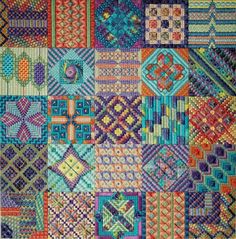 a quilt with many different designs on it