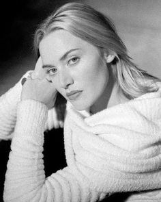 a black and white photo of a woman wearing a sweater