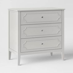 a white chest of drawers with three drawers on each drawer and one drawer in the middle