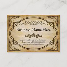 a business card with an ornate frame on it