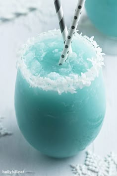 two straws sticking out of the top of a blue drink with snow flakes on it