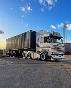 a large semi truck parked on top of a parking lot