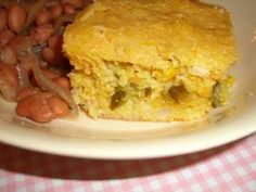 a white plate topped with cornbread and beans