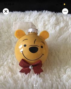 a winnie the pooh christmas ornament with a bow on it's head