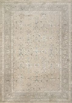 an antique rug with many different colors and patterns on the carpet is shown in grey tones