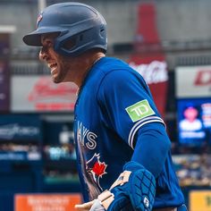 a baseball player holding a bat in his hand and wearing a catchers mitt