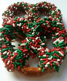 a doughnut covered in sprinkles and green, white, and red