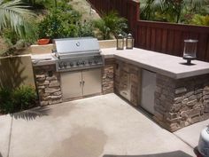 an outdoor bbq and grill area in a backyard