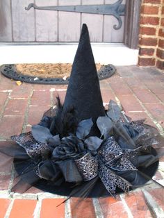 a black witch's hat is sitting on the ground