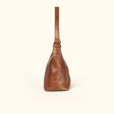 Walker Leather Shoulder Bag | Rustic Tan hover Cognac Bags With Brass Hardware And Top Handle, Cognac Top Handle Bags With Brass Hardware, Cognac Bag With Brass Hardware And Top Handle, Everyday Timeless Leather Shoulder Bag, Timeless Leather Shoulder Bag For Everyday, Timeless Soft Leather Hobo Shoulder Bag, Timeless Cognac Shoulder Bag With Adjustable Strap, Timeless Crossbody Shoulder Bag With Brass Hardware, Business Shoulder Bag In Vegetable Tanned Leather