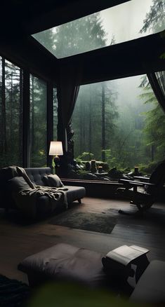 a living room filled with lots of furniture next to a window covered in foggy trees