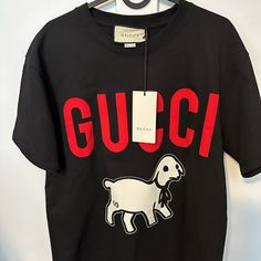 Oversized Gucci Lamp T-Shirt. Only Tried It On. New With Tags. Gucci Designer Black T-shirt, Designer Gucci Black T-shirt, Gucci Black T-shirt With Logo Print, Trendy Gucci Crew Neck T-shirt, Gucci Cotton T-shirt With Graphic Print, Gucci Cotton T-shirt With Logo Print, Gucci Cotton Graphic Print T-shirt, Black Gucci Tops With Letter Print, Gucci Black Crew Neck Top