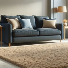 a blue couch sitting on top of a rug in a living room