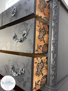 an old dresser has been painted with metallic and wood flowers on the drawers, as well as metal pulls