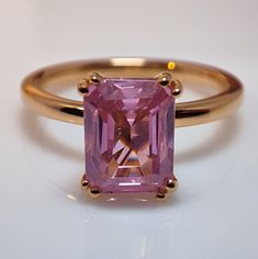 an engagement ring with a pink diamond in the center