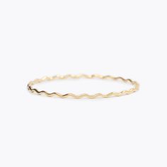 This wavy design was inspired by the gold edges of Susan Gordon’s signature handmade pottery. A collaboration piece between SGP and Yearly Co. perfect for representing the ups and downs in life. A 1.8mm round, solid 14k gold bangle.If you want to customize a Wavy Bangle with diamonds, email us at hello@yearlyco.com. Everyday Yellow Gold Wavy Jewelry, Everyday Wavy Yellow Gold Jewelry, Gold Wavy Jewelry For Everyday, Minimalist 14k Gold Wavy Jewelry, Minimalist Wavy Yellow Gold Jewelry, Ups And Downs In Life, Bangle With Diamonds, Surprises For Husband, Wavy Design