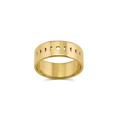 a yellow gold wedding ring with holes in the middle