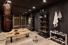 a boxing gym with punching gloves and other items on the wall, in front of a wooden table