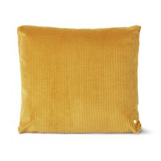 a mustard colored pillow on a white background