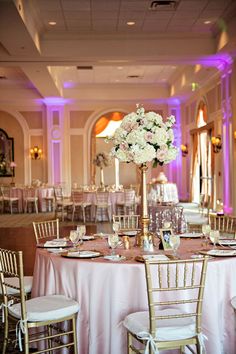 the tables are set with white and pink flowers