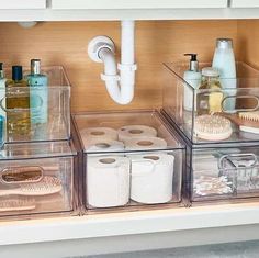 the bathroom drawer is organized with clear containers and toiletries, such as soaps, toothbrushes, and other personal care items