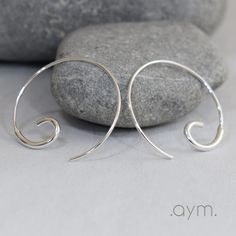 "Hand forged solid sterling silver open hoop threader earrings. Lightweight, comfortable and easy to wear, these stylish earrings go with everything.  Perfect to wear everyday. Available in 2 sizes.  The larger size (approximately 1\") is formed from a larger gauge wire curve soldered to a smaller gauge wire that goes through the ear.  The smaller size (approximately 3/4\") is formed from one continuous smaller gauge wire that is curved and hammered at one end. - Gift-boxed. - In stock and ships Minimalist Spiral Sterling Silver Hoop Earrings, Minimalist Spiral Hoop Earrings In Sterling Silver, Modern Sterling Silver Threader Earrings, Modern Adjustable Sterling Silver Threader Earrings, Simple Silver Sterling Threader Earrings, Modern Silver Threader Earrings With Ear Wire, Silver Round Threader Earrings For Everyday, Adjustable Silver Sterling Threader Earrings, Nickel-free Silver Threader Earrings In Sterling Silver