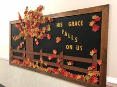 a bulletin board with leaves on it that says his grace falls on us