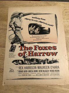 an old movie poster for the fox's of harrow on a wooden table top