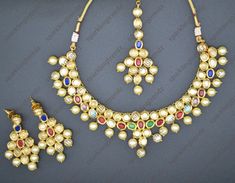 Premium quality Amira Navratan Kundan choker necklace set with Tikka & pearl drop. Comes with an adjustable dori. Earrings length: 2". Push-Back closure. Light-weight. Gold Plated on 100% Brass as a base metal. Available in Stock. *Color may vary slightly due to light condition & photography. Jewelry Care: Keep away from moisture. Allow perfumes and lotion to dry before wearing. Store in jewelry pouch. Clean only with soft lint free cloth. Kundan Choker Necklace, Indian Choker, Indian Choker Necklace, Photography Jewelry, Kundan Choker, Pakistani Jewelry, Choker Necklace Set, Jewelry Indian, German Silver