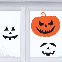 two windows decorated with halloween pumpkins and jack o lantern faces