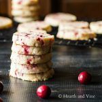 a stack of cranberry shortbread cookies sitting on top of a cookie sheet