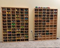 two wooden shelves filled with lots of toy cars on top of carpeted flooring