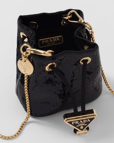 Find PRADA Sequined Satin Mini Pouch on Editorialist. This Prada pouch features a drawstring closure, an enameled metal triangle logo on the closure, and a removable chain shoulder strap. The interior is lined in logo-print nylon. It can be worn on the shoulder or carried as a mini bag. Bags With Chains, Evening Bags With Logo Charm, Luxury Evening Bag With Metal Logo, Luxury Evening Bags With Metal Logo, Elegant Evening Bag With Logo Charm, Chic Evening Bags With Logo Charm, Luxury Formal Bags With Logo Charm, Luxury Bags With Logo Charm For Gift, Designer Party Bags With Metal Logo