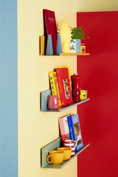 two shelves with books and cups on them