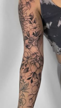 a woman's arm with flowers on it