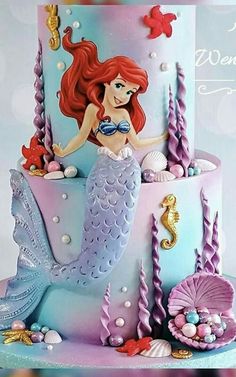 the little mermaid is sitting on top of this cake