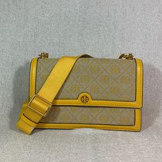 Brand New Never Been Carried Price Is Firm Goldfinch T Monogram Jacquard Shoulder Bag By Tory Burch Made Of Beautiful Yellow Monogram Jacquard With Leather Trim 10.8" Wide Across Bottom X 7.2" Tall Center X 3" Deep. Long Strap 18.5" Drop Flap Closure 2 Compartments Interior: 1 Zippered Center Divider Compartment, 2 Slip Pockets On Both Front And Back Microsuede Lining. Brass Tone Metalware. Comes With Dust Bag High Demand In Season Item. Tag Was Be Removed To Prevent Store Return. Gold Monogram Canvas Shoulder Bag, Gold Monogram Canvas Crossbody Shoulder Bag, Luxury Yellow Rectangular Shoulder Bag, Gold Monogram Canvas Satchel Shoulder Bag, Gold Monogram Canvas Shoulder Bag With Detachable Strap, Designer Yellow Rectangular Shoulder Bag, Classic Yellow Rectangular Shoulder Bag, Luxury Yellow Crossbody Shoulder Bag, Designer Yellow Shoulder Bag With Removable Pouch