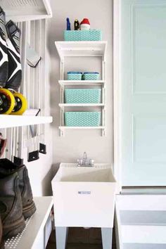 a white sink sitting next to a closet filled with shoes