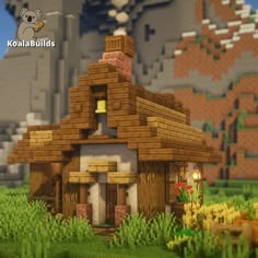 an image of a small house in the middle of some grass and rocks with a mouse on it