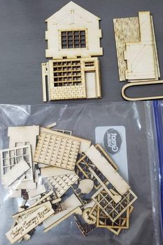 wooden model kits and tools for building a house in the shape of an old church