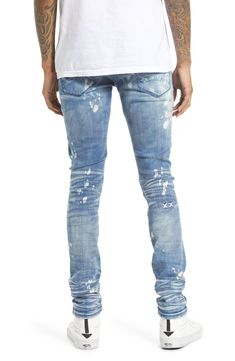 These super-skinny stretch-denim jeans are given a punk-rock update with a bleached wash covered in rips and paint splatters. A branded utility belt adds to the grunge aesthetic. 32" inseam; 11 1/2" leg opening; 10 1/2" front rise Zip fly with button closure Five-pocket style Removable utility belt 86% cotton, 10% spandex, 4% polyester Machine wash, line dry Imported Men's Clothing Urban Style Distressed Fitted Jeans, Urban Distressed Fitted Jeans, Ripped Fitted Punk Jeans, Punk Ripped Fitted Jeans, Punk Style Ripped Fitted Jeans, Fitted Ripped Punk Jeans, Fitted Punk Jeans With Five Pockets, Punk Style Fitted Jeans With Five Pockets, Fitted Punk Style Jeans With Five Pockets