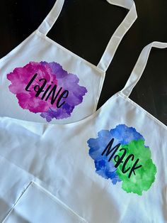 two aprons with painted words on them that say lanic and mack in different colors