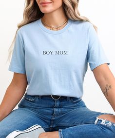 "Boy Mom Tee, Boy Mama Shirt, Mom Shirt, Mama Shirt, Mom Gift, Mothers Day Gift, Boy Mom Club, Cute Mom Apparel, Boy Mom Gift, Mom Gift for Her, Gift Idea, Minimalist Gift, Mom Life Shirt, Cute Mom Shirt, Mom of Boys, Baby Shower Gift DETAILS Our Bella & Canvas tees are soft and very comfy. This tee is a modern, more fitted style. They run smaller for unisex sizing, so please make sure to choose your size accordingly! For a more relaxed and oversized fit, we recommend sizing up. Please check our sizing charts for reference to make sure you get the perfect fit. FABRIC Bella & Canvas 3001 Unisex Jersey Tee -- 4.2 oz. 100% Airlume Ring-spun Cotton -- Preshrunk. MATERIALS Handmade and heat pressed with quality heat transfer vinyl. PERSONALIZATION Personalization is not available for this item, Family Matching Slogan Cotton T-shirt, Family Matching Cotton Slogan T-shirt, Mother's Day Graphic Tee With Text Print, Trendy Blue Top With Funny Text, Light Blue Cotton T-shirt For Everyday, Mother's Day Crew Neck Tops With Funny Text, Cute Relaxed Fit Tops With Name Print, Blue Graphic Print Top For Mother's Day, Mother's Day Cotton Shirt With Funny Text