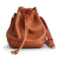 Handemade Leather Crossbody Drawstring Pouch Bag with Seam Details Made from cowhide Adjustable leather strap with seam details One main compartment Hand stitched with waxed thread Width x Height x Depth:  Practical, stylish and useful. It is designed to add an original touch to your casual style. Brown Smooth Grain Bucket Hobo Bag, Casual Leather Bucket Bag In Cognac, Travel Bucket Bag With Leather Strap, Casual Cognac Leather Bucket Bag, Brown Leather Pouch With Smooth Grain, Leather Crossbody Bucket Bag With Smooth Grain, Everyday Leather Bucket Pouch, Leather Travel Pouch With Adjustable Strap, Brown Bucket Pouch For Everyday Use