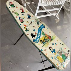 an old ironing board with cartoon characters on it